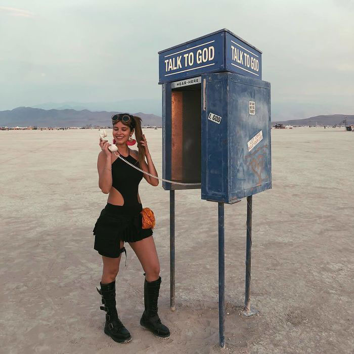 A person standing next to a pay phone

Description automatically generated with medium confidence